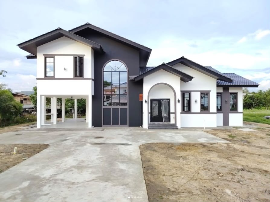 Split-level residence with arched feature entrance in Brunei Darussalam by Alek Jaya Sdn Bhd